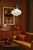 A striking Danish Mid-Century Modern pendant light, combining a beautifully textured opalescent glass globe with warm...