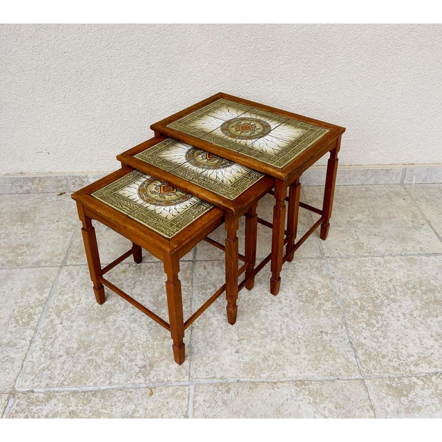 Stunning set of three scandinavian nesting tables, made in denmark in the 1960s. solid teak wood frame with clean lines...