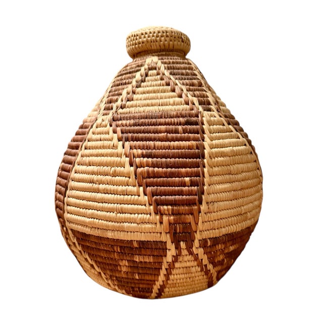 A group of four charming assorted woven baskets, featuring a woven pine needle Papago basket. Intricate patterns and...