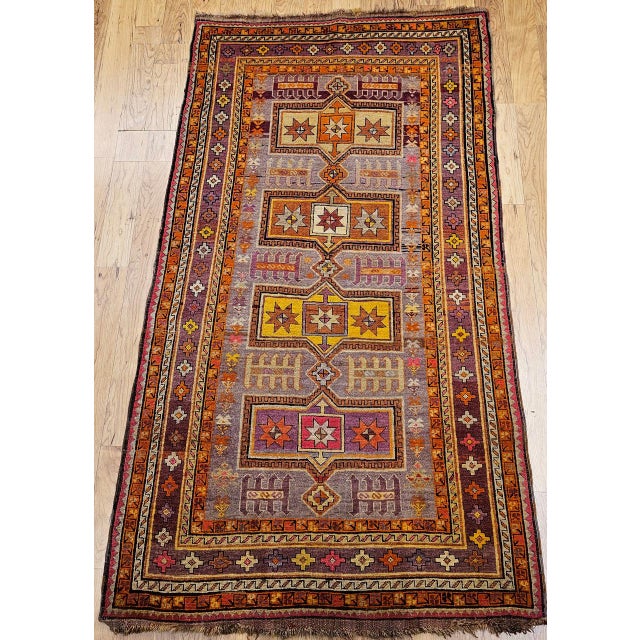 A vibrant and colorful vintage Moroccan area rug has a geometric pattern that is designed to make its presence felt and...