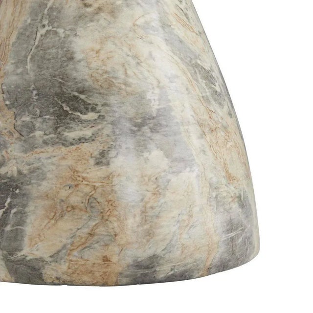 Tricky, like trompe l’oeil, this stunning table has a secret—though it looks to be made completely of stone, lift it and...