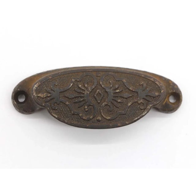 Ornate Victorian bin pull made of cast iron with a black finish. One available. The manufacturer and exact date of...