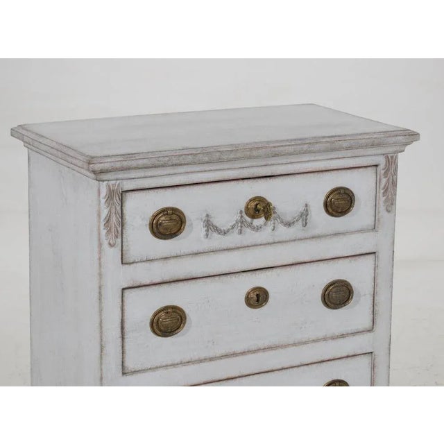 Small swedish chest with three drawers and ornaments, original hardware and key, circa 100 years old h. 71 w. 66 d. 35 cm...