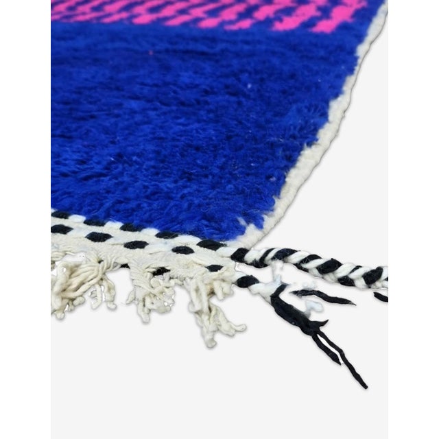 Modern Boujad Rug | Handwoven Wool Rug in Cobalt Blue & Pink with Wavy Stripe Border This vibrant modern Boujad rug pairs...