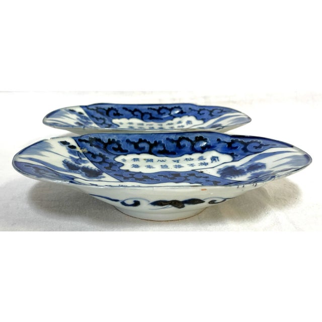 Elegant pair of vintage Japanese porcelain plates. They have hand painted designs including Asian symbols and foliage...