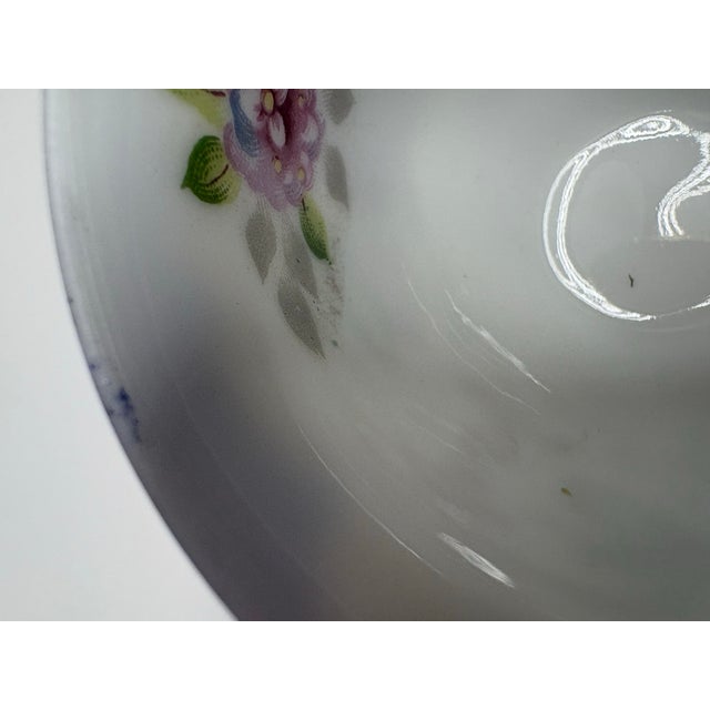 Elegant vintage Ucagco China teacup and saucer made in Occupied Japan (1940s–50s). Features a cobalt blue rim, hand-...