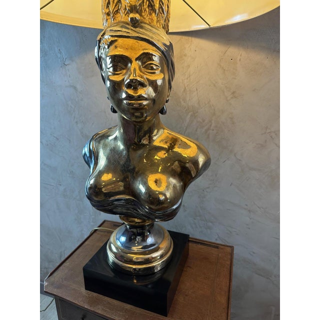 Magnificent and rare substantial lamp in gold and silver ceramic dating from the 60s representing an African woman with...