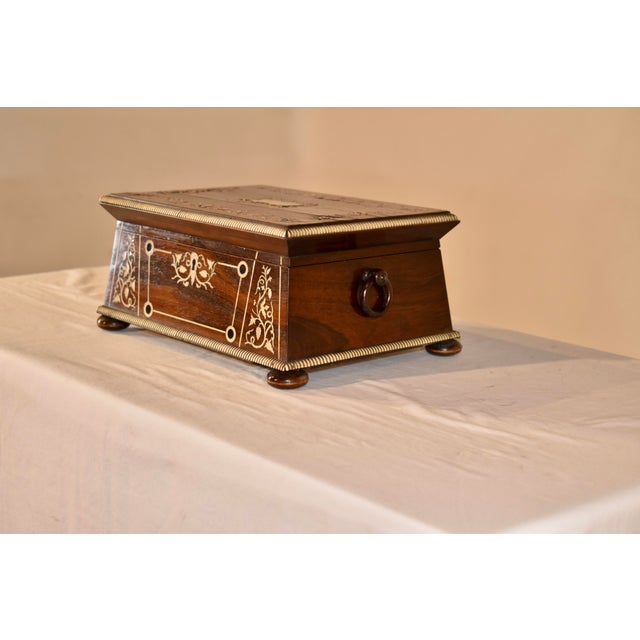 19th century English dresser box made from exquisitely grained rosewood. The box has wonderfully inlaid patterns on the...