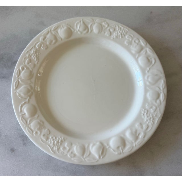 Set of 5 vintage glossy white dinner plates made in Italy by Windsor & Browne. Plates feature an embossed rim with a...