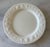 Set of 5 vintage glossy white dinner plates made in Italy by Windsor & Browne. Plates feature an embossed rim with a...
