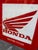 Vintage enamelled iron sign from the well-known Honda brand with some signs of wear due to the passage of time.