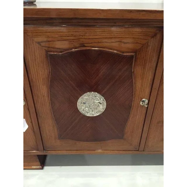 This spectacular five door French Art Deco credenza has silver plaques on each door with a deer motif. The center door...