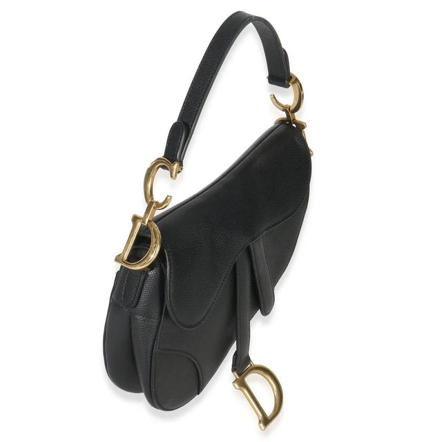 Designed by John Galliano in 1999, Dior's saddle bag made its debut on the SS00 runway. The cowboy-inspired accessory has...