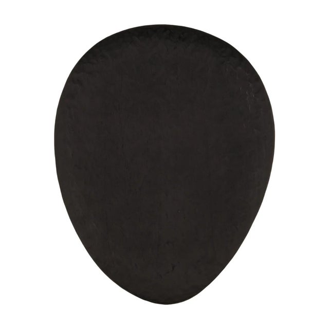 Hand chiseled wood three-leg side table with handsome black finish. Unique egg shaped top. Modern mixed with a primitive...