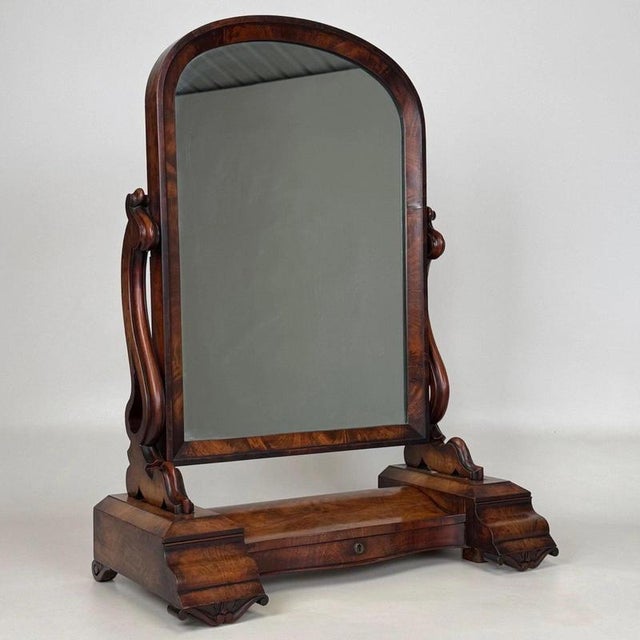 A charming 19th-century English Victorian dressing mirror, finely crafted from mahogany and combining an elegantly shaped...
