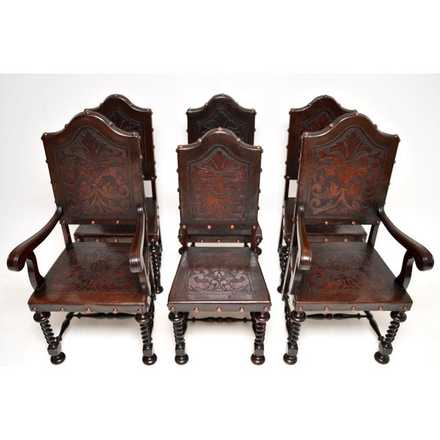 A charming set of six antique Portuguese embossed leather and walnut dining chairs, dating from around 1880-1900. They are...