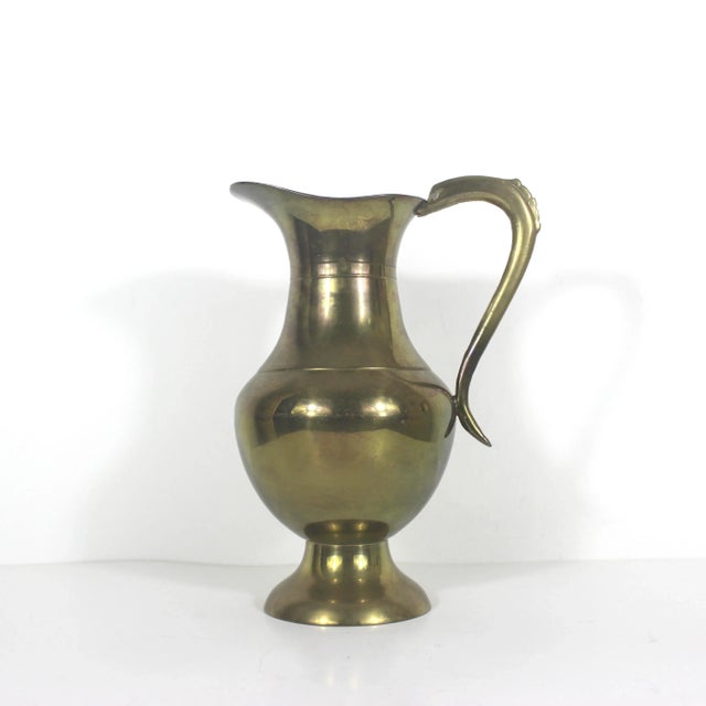 Great heavy, vintage brass water pitcher with handle. Would look great on an open kitchen shelf or use as a vase....