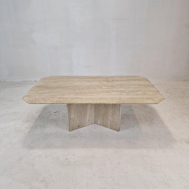 Very nice Italian coffee or side table handcrafted out of travertine, 1980s. It has a very nice 3-leg base. It is made of...