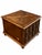 A distinctive vintage cabinet end table featuring a warm brown finish, a geometric figured top, and four decorative cane-...
