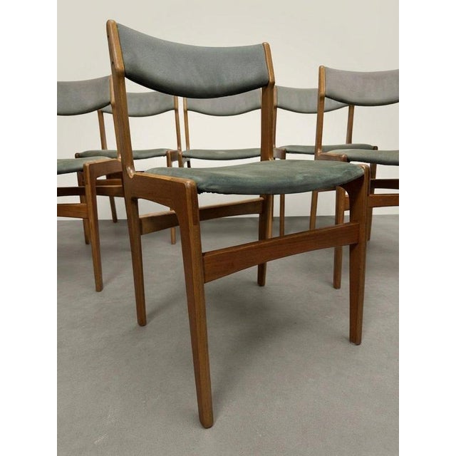 Elevate your dining space with this exceptional set of six mid-century dining chairs. Manufactured in Denmark during the...