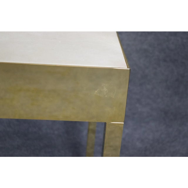 This sleek contemporary brass flashed console table is designed in the celebrated Milo Baughman style, capturing the...