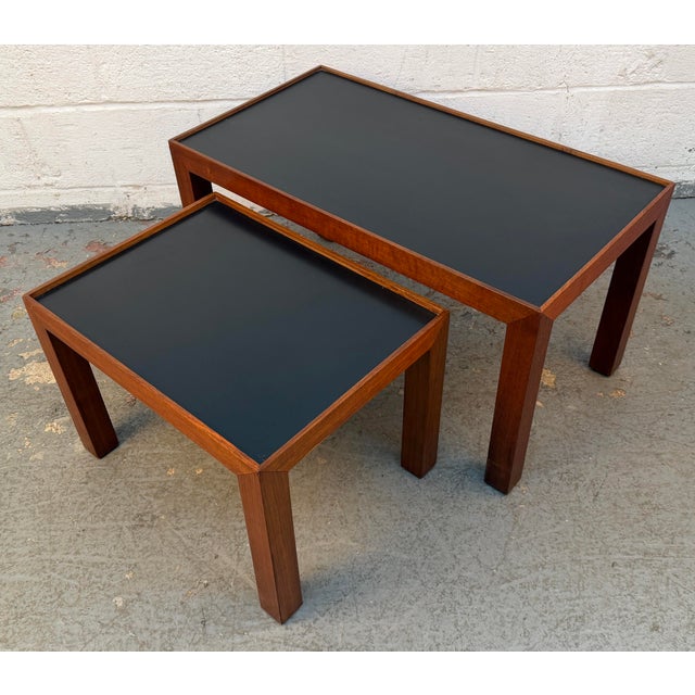 Elevate your living space with this exceptional set of two mid-century modern nesting tables. Masterfully crafted with...
