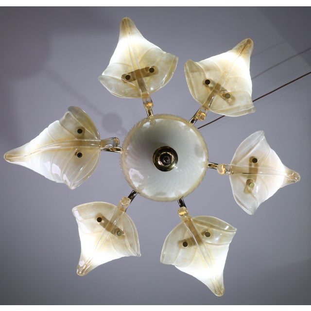 Exceptional gold-colored Murano glass chandelier. Production period: 1970–1980. Holds 6 bulbs; can be wired for U.S. use....
