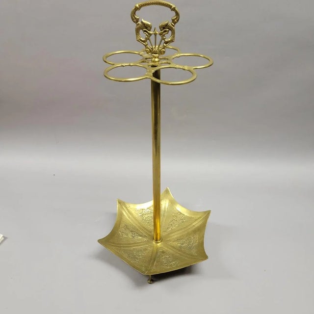 A English inspired brass umbrella stand in the shape of a parasol with a serpentine handle. Holds 5 umbrellas securely, it...