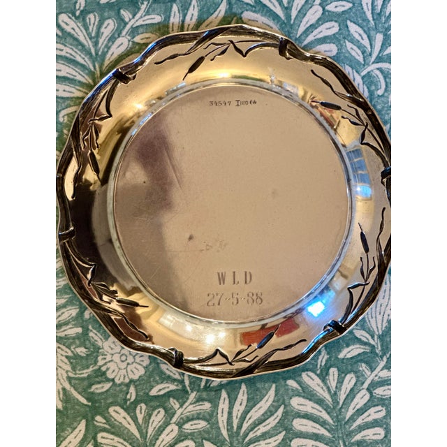 A beautiful small silver dish/plate that could be used as a wine coaster, tray for hors d'oeuvres, or bread plate....