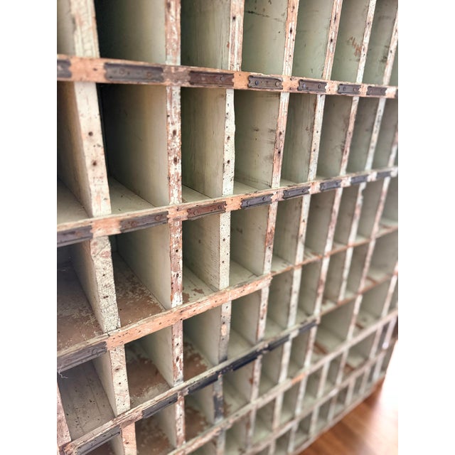 An authentic antique wooden printer’s type case cabinet, featuring approximately 120 individual compartments originally...