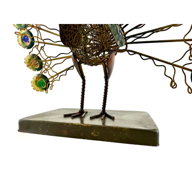 This vintage Mid Century metal peacock is a dazzling spectacle of craftsmanship. The piece features a fan of plumes, each...