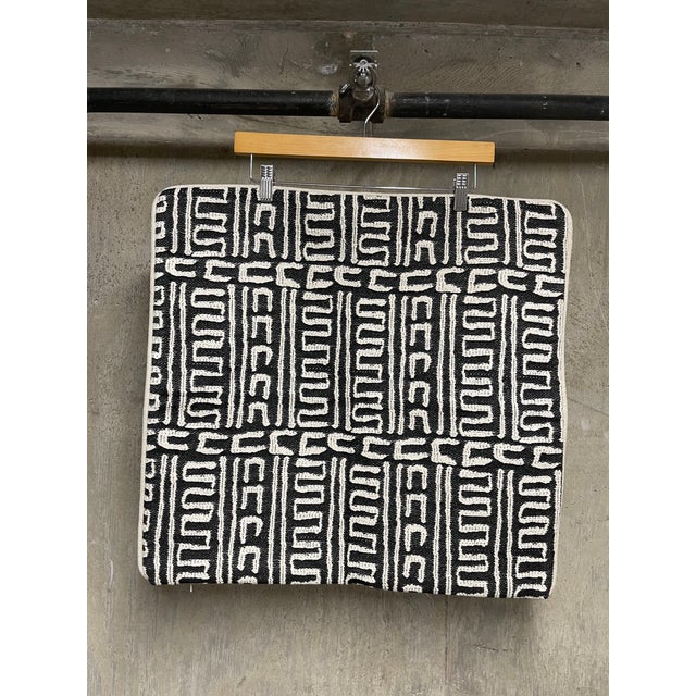 This newly crafted 22” X 22” accent/throw pillow features a bold black and cream tribal-inspired geometric motif fabric....