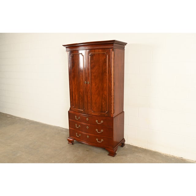 A gorgeous Georgian or Chippendale style armoire dresser, gentleman's chest, linen press, or media cabinet By Baker...