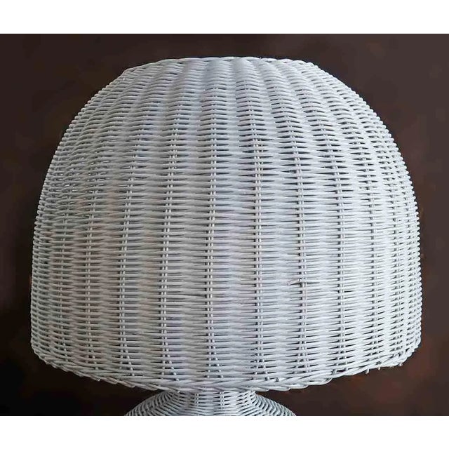 Mid century modern white wicker table lamp. Shade is mushroom shaped and cord is brown.