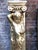 A pair of 20th century gold gilded ionic columns with winged cherubs and fish scaled plinths. These classical columns are...