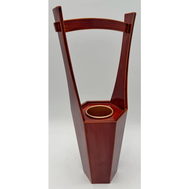 Elegant Japanese modernist ikebana vase stand executed in the traditional Hida Shunkei style, featuring a warm translucent...