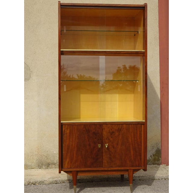 A high-quality display cabinet from the 1950s, made by Maison Capelle in Montauban (82), France. The cabinet is crafted...