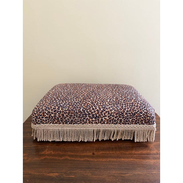 A gorgeous French style footstool upholstered in a leopard print fabric with gold fringe USA, Late 20th Century Measures:...