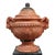 This is a pair of Neoclassical-style garden urns, crafted from terra cotta with black-painted accents, dating to the 20th...