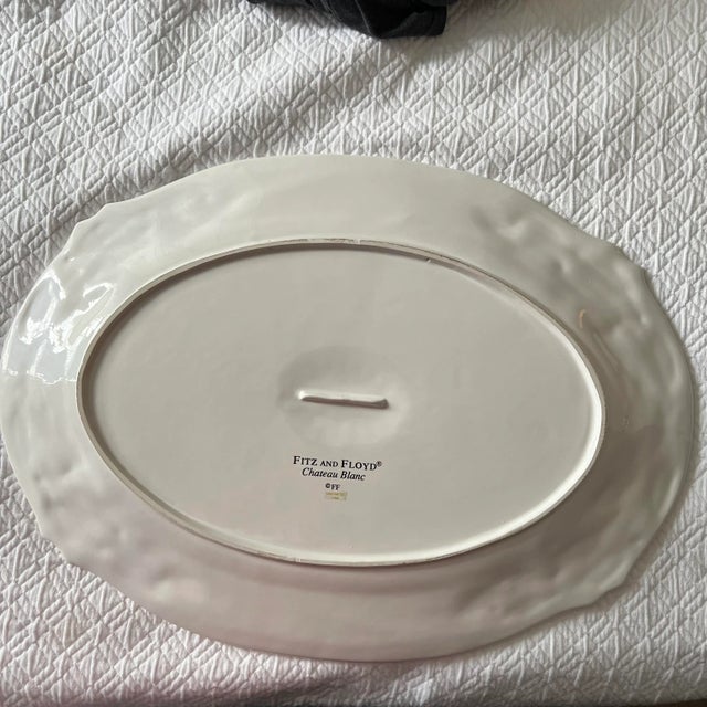 Fitz and Floyd Chateau Blanc platter with holly and berries border. Measures 21.5” w x 1” derp x 15.5” high. Has two holes...