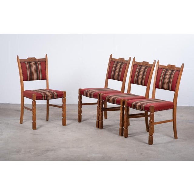 Set of solid oak dining chairs attributed to Danish designer Henning Kjærnulf, crafted in Denmark during the 1960s....