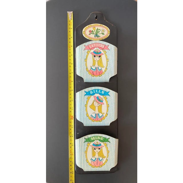 A colorful wall mounted mail holder from Japan, circa mid 20th century. There are three modernist style wall shelves...