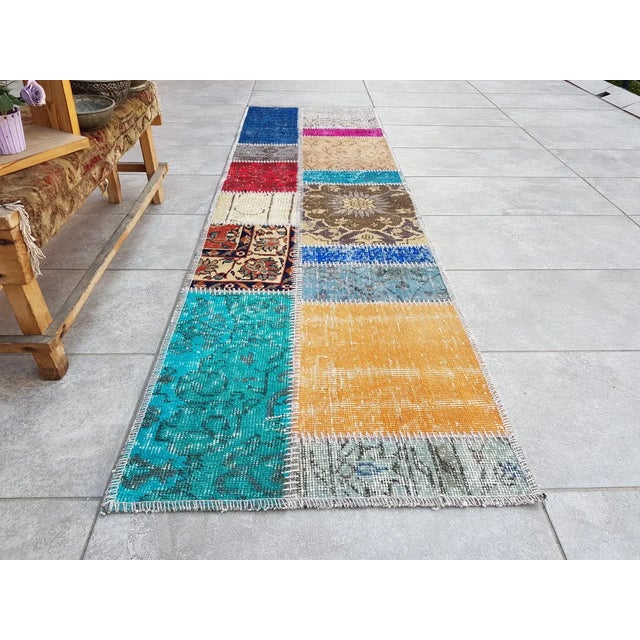 This is a vintage Turkish Oushak rug from the Mid 20th Century. The piece was hand-knotted.