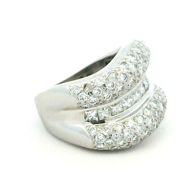 Crafted in 18-karat white gold, this contemporary Italian crossover ring showcases 3.74 carats of diamonds in a striking...