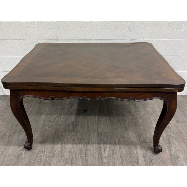 This is an absolutely gorgeous vintage French Louis XV or French Provincial style parquetry top draw leaf refectory dining...