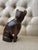 Hand-carved wooden cat figurine with a smooth, sculptural silhouette and rich dark brown finish.