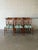 This set of six dining chairs features an open silhouette defined by elegant vertical slat backs. The timeless profile...