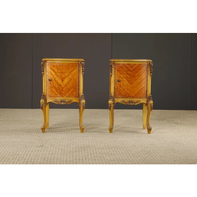 This lovely pair of Louis XVI French Provincial styled bedside tables feature ample interior cabinet space, gorgeously...