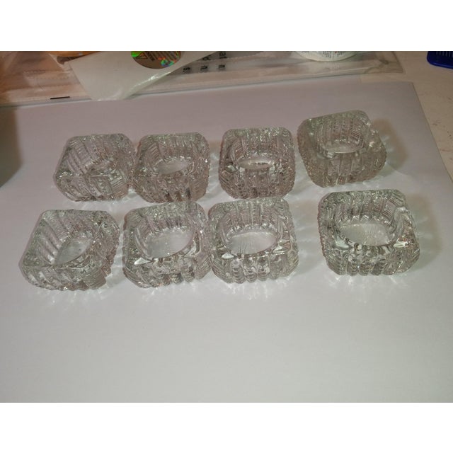 Eight crystal salt cellars in the original box. These were made by Cambridge in the 1940's. The edges are scalloped. The...