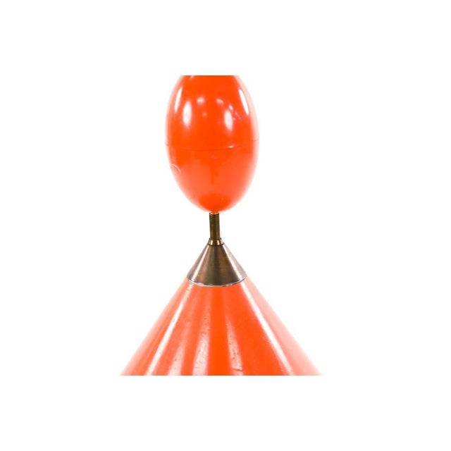 A 1960's Danish Modern orange metal cone-shaped pendant light with perforated edges. The lamp was designed by Poul...